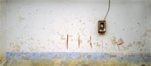 photograph of electric meter on wall with abstract surface patterns