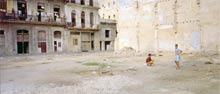 photograph of children playing on waste ground  on street in Havana Cuba 1997