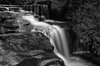 B&W photograph of waterfall showing slow shutter speed motion blur