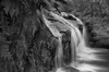 B&W photograph of waterfall showing slow shutter speed motion blur