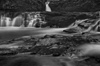 B&W photograph of waterfall showing slow shutter speed motion blur