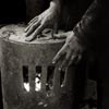 photograph of coal miner's hands warming by a fire